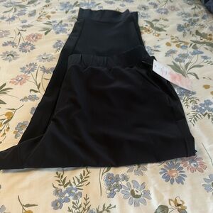 Black ankle travel pants with slit in hem, back pockets